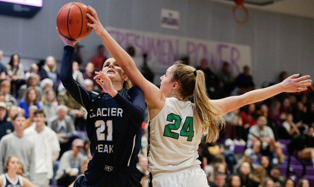 Woodinvilles Mia Hughes blocks Glacier Peaks Sydney Guffey. (Andy Bronson / The Herald)