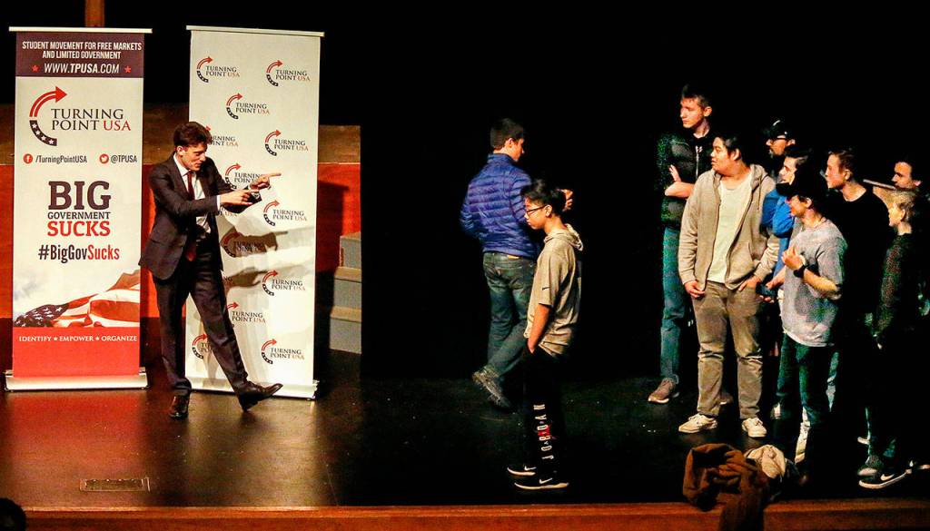 Speaker Kyle Kashuv greets a group of boys who came up on stage to take photos with him following his talk about gun rights and school shootings. (Dan Bates / The Herald)