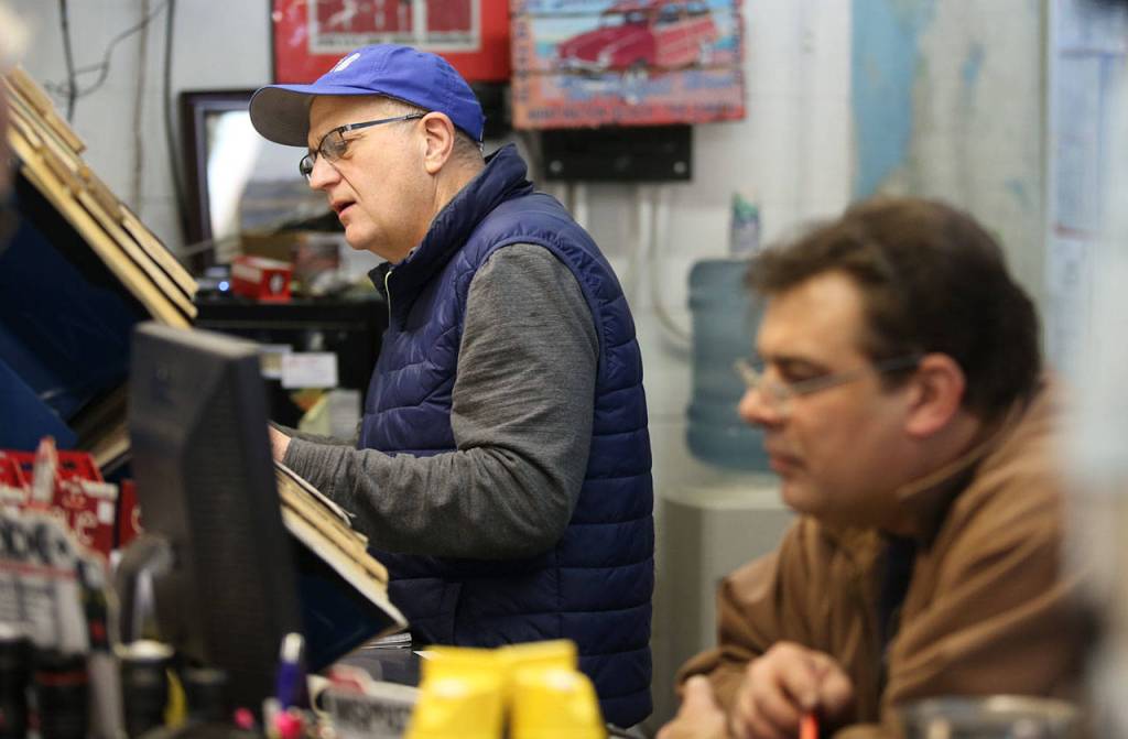 Greg Ouellette (left) and Travis Wood search for parts at Edmonds Auto Parts and Marine Supply. (Kevin Clark / The Herald)