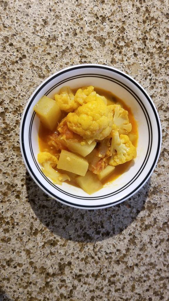 Potato-cauliflower curry is a hearty Indian dish best served hot. (Megan Campbell / The Herald)