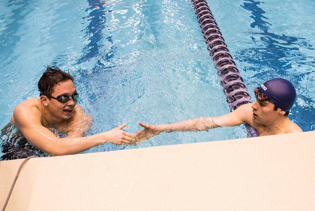 Jacksons Justin Limberg shakes hands North Creeks Brandon Stride after competing in the Mens 100 Yard Breaststroke uring the 4A Boys Swim/Dive Championships on Saturday, Feb. 16, 2019 in Federal Way, Wash. (Olivia Vanni / The Herald)