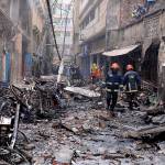 Firefighters on Thursday gather around buildings that burned late Wednesday night in Dhaka, Bangladesh. (AP Photo/Mahmud Hossain Opu )