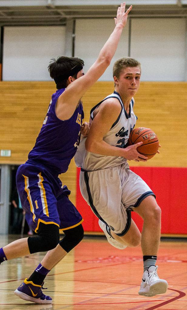 Glacier Peaks Caleb Lee (right) drives to the hoop during Fridays 4A state regional game against Issaquah at Everett Community College. (Olivia Vanni / The Herald)