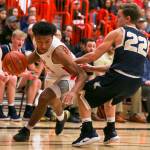 Marysville Pilchucks RaeQuan Battle drives the baseline with Kelsos Dillon Davis defending during a state regional game on Feb. 23 at Everett Community College. The Tomahawks won 72-51. (Kevin Clark / The Herald)