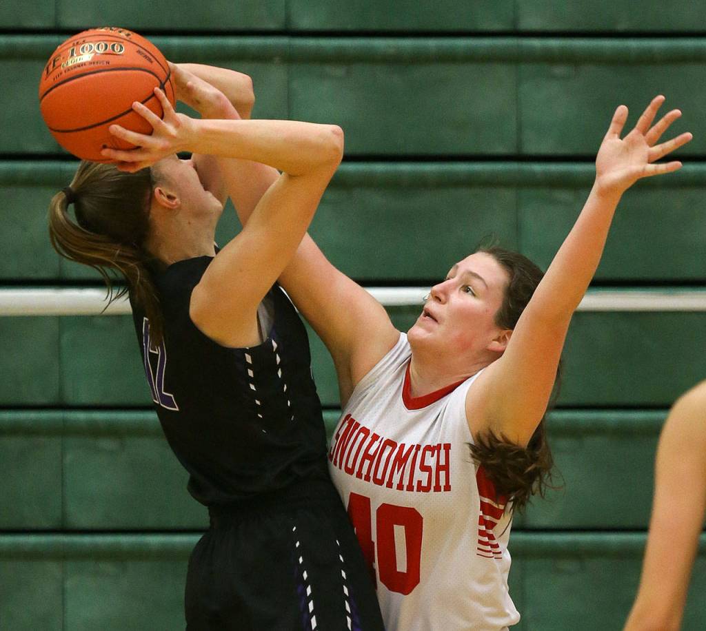 Snohomish senior Courtney Perry (right) blocks a shot by 6-foot-3 Lake Washington freshman Elise Hani. (Kevin Clark / The Herald)