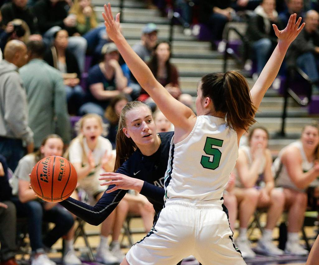 Glacier Peaks Madison Rubino tries to find a teammate to pass to as Woodinvilles Katie Minnehan blocks her. Glacier Peak lost to Woodinville 64-54 in a girls basketball game at North Creek High on Feb. 18 in Bothell. (Andy Bronson / The Herald)