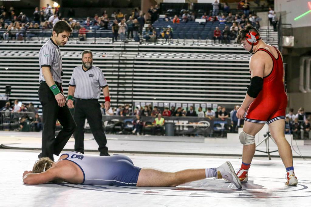Sultans Tyler Deason is left dejected after falling to Grangers Gage Cook in the 220 weight class during the Mat Classic XXXI at the Tacoma Dome on Feb. 15 in Tacoma. Deason finished second in state. (Kevin Clark / The Herald)
