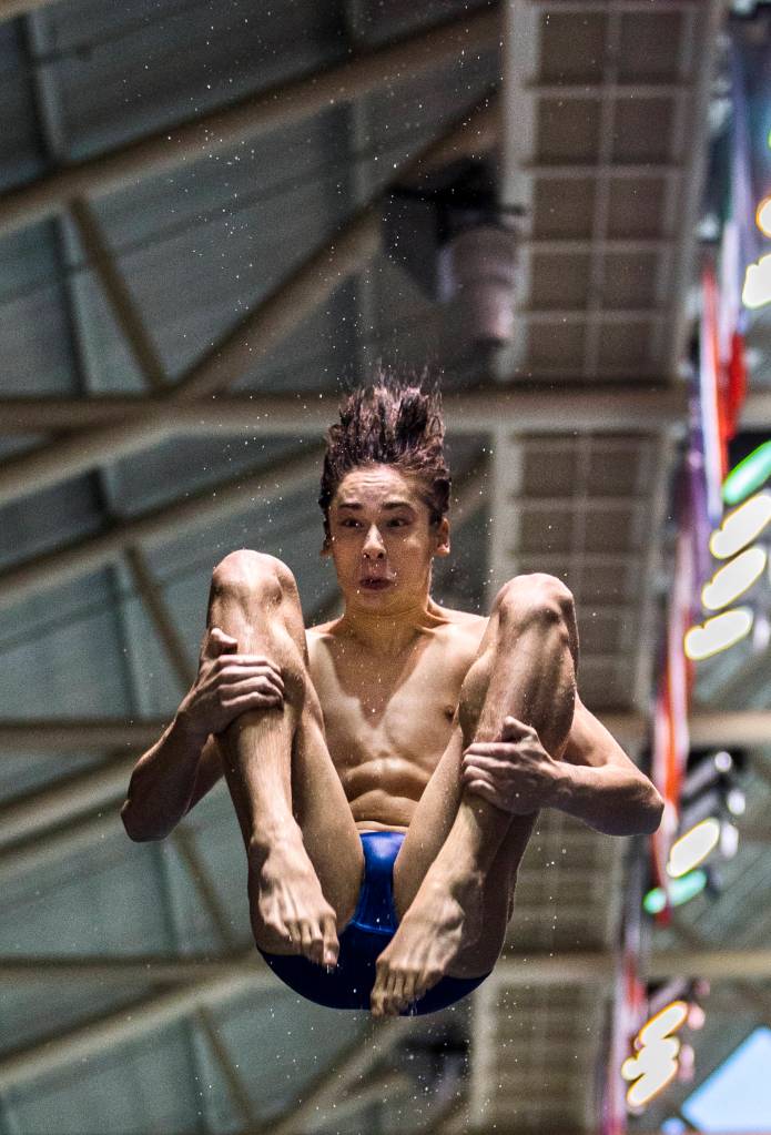 Shorewoods Isaac Poole warms up before the Boys 1 Meter Diving during the 3A Boys Swim/Dive Championships on Feb. 16 in Federal Way. (Olivia Vanni / The Herald)