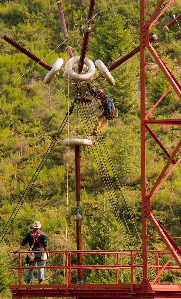 Contractors work on the insulator of one of the 35 antenna towers at Jim Creek Naval Radio Station in 2012. (Robin Hicks / U.S. Navy)