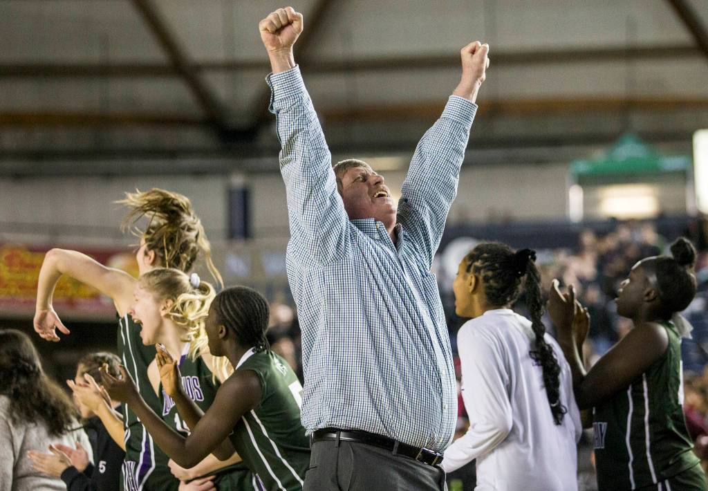 Edmonds-Woodway head coach Jon Rasmussen puts his hands in the air in celebration after Bethels Tiarra Brown fouls out of the game during the game against Bethel at the 3A Girls Hardwood Classic on Wednesday, Feb. 27, 2019 in Tacoma, Wash. (Olivia Vanni / The Herald)