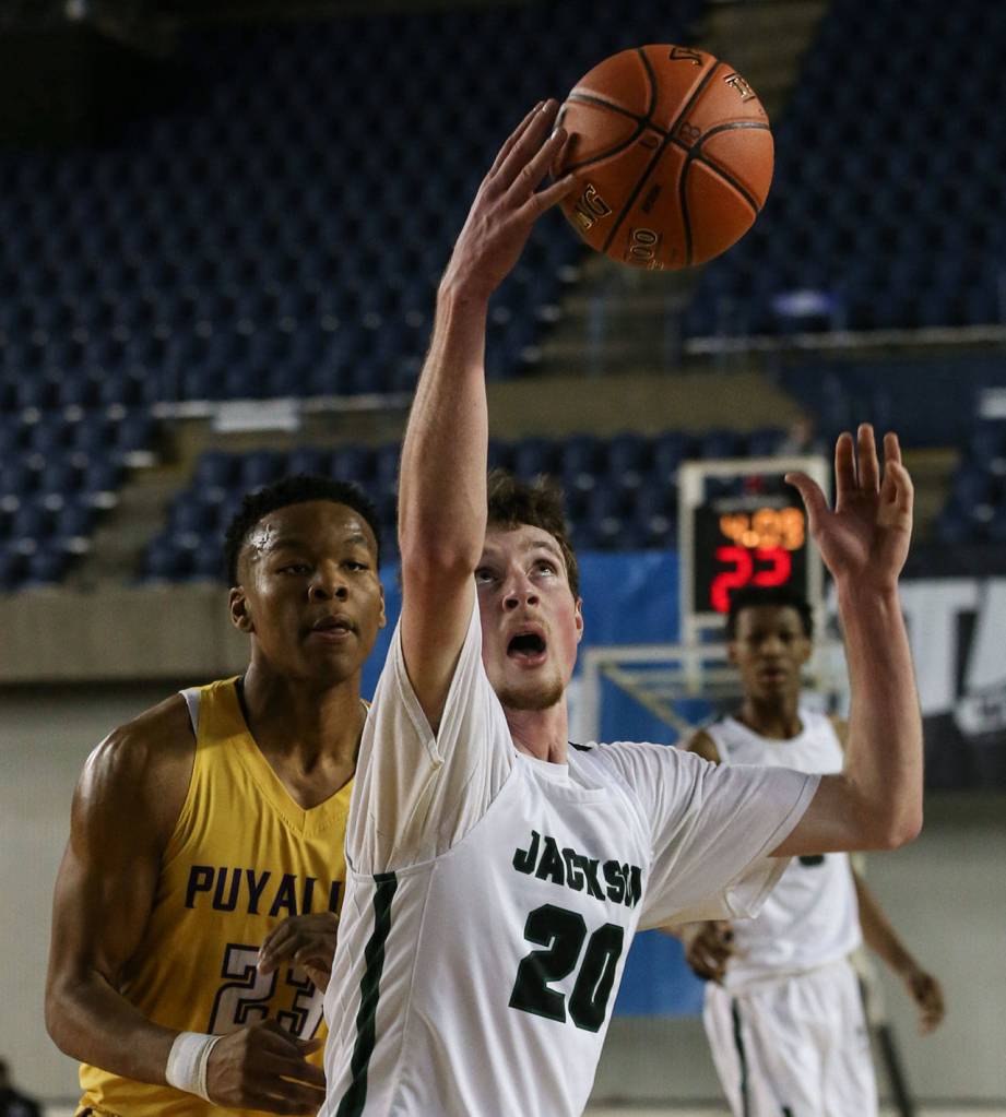 Jacksons Kyle Bigovich gathers a loose ball with Puyallups Kendell Munson defending Wednesday morning at the Tacoma Dome on February 27, 2019. The Timberwolves lost 56-50. (Kevin Clark / The Herald)