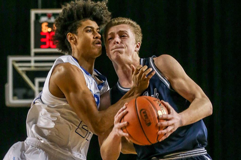 Glacier Peaks Evan Mannes drives the lane with Curtis Josiah Miller defending Wednesday afternoon at the Tacoma Dome on February 27, 2019. The Grizzles lost 46-43. (Kevin Clark / The Herald)