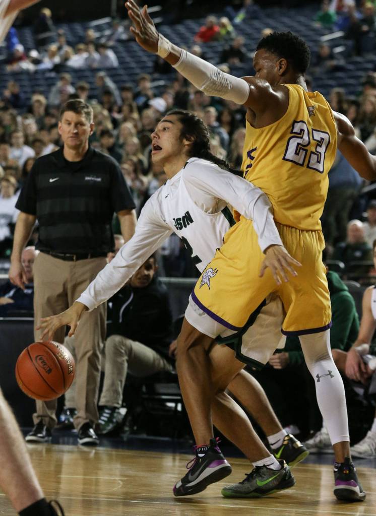 Jacksons Jesse Hoiby works to get around Puyallups Kendell Munson Wednesday morning at the Tacoma Dome on February 27, 2019. The Timberwolves lost 56-50. (Kevin Clark / The Herald)