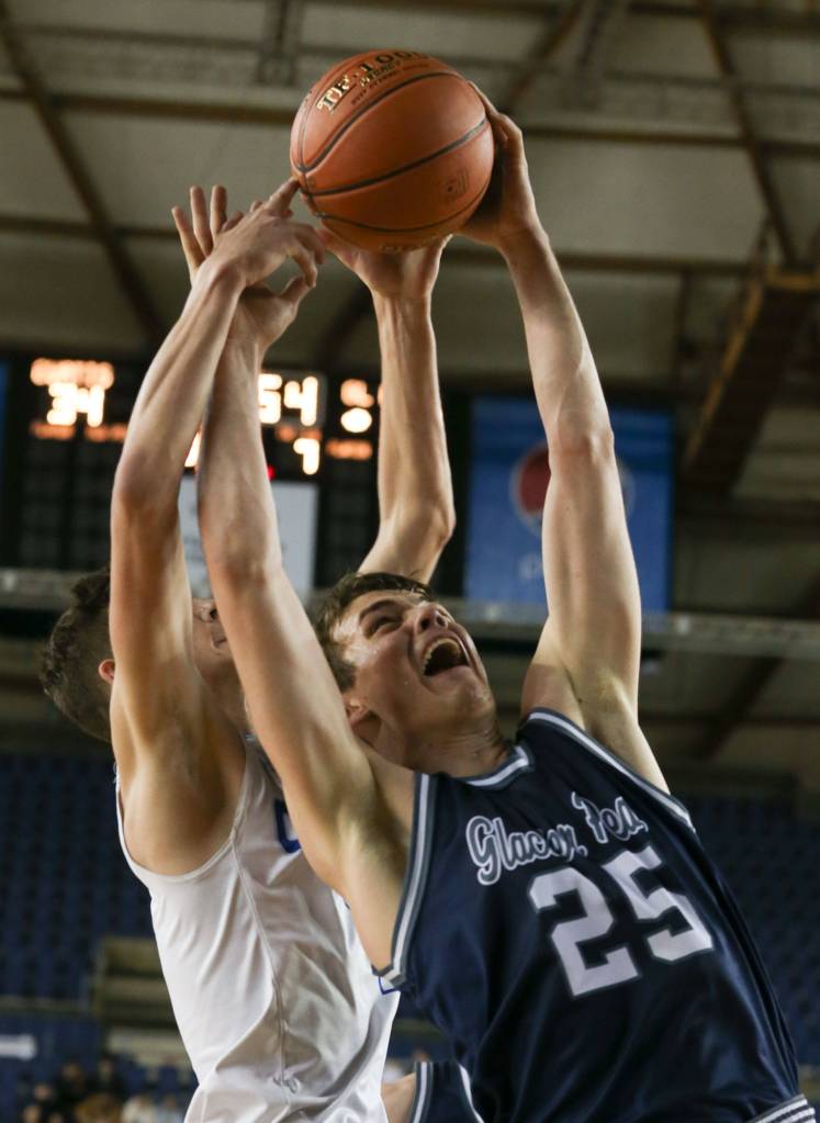 Glacier Peaks Noah Forman (left) and Curtis Zack Paulsen jump for a rebound with Wednesday afternoon at the Tacoma Dome on February 27, 2019. The Grizzles lost 46-43. (Kevin Clark / The Herald)