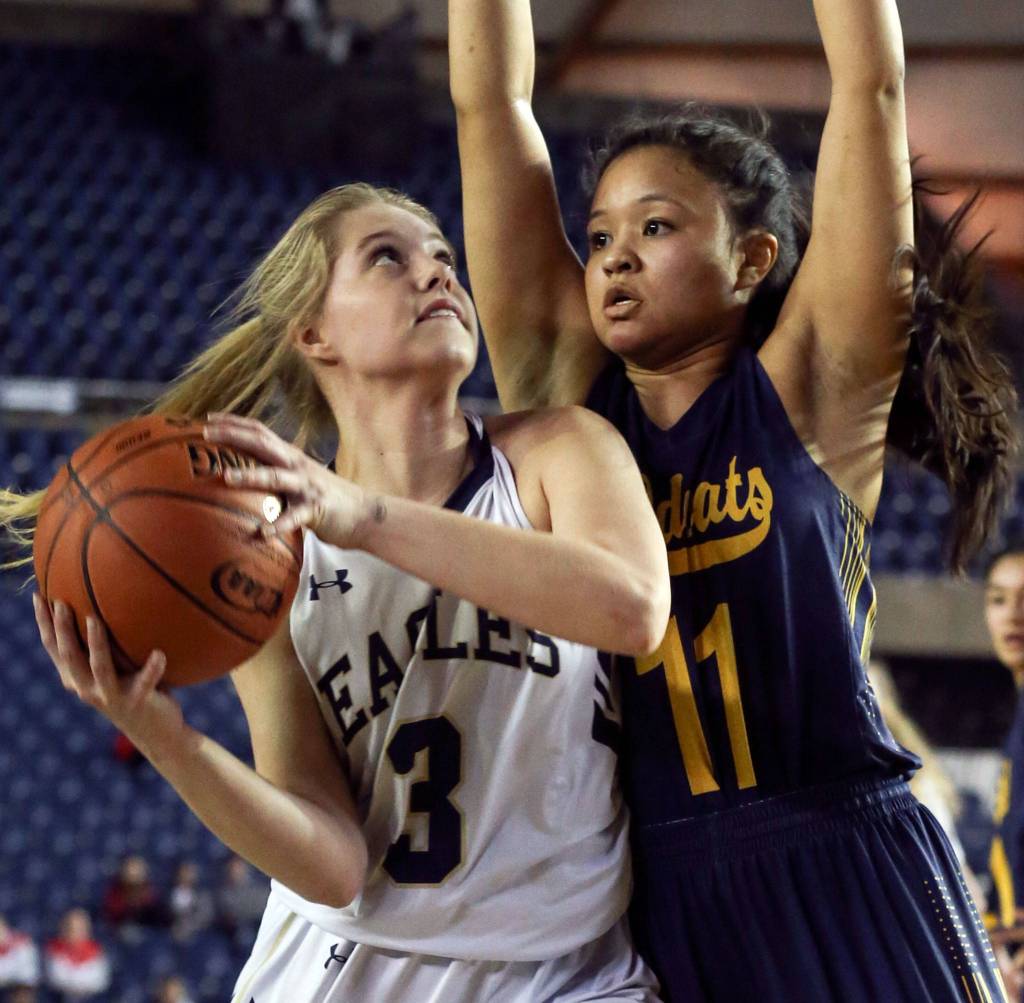 Arlingtons Abby Schwark looks to score with West Seattles Jasmine Gayles defending Wednesday afternoon at the Tacoma Dome on February 27, 2019. The Eagles lost 50-45. (Kevin Clark / The Herald)