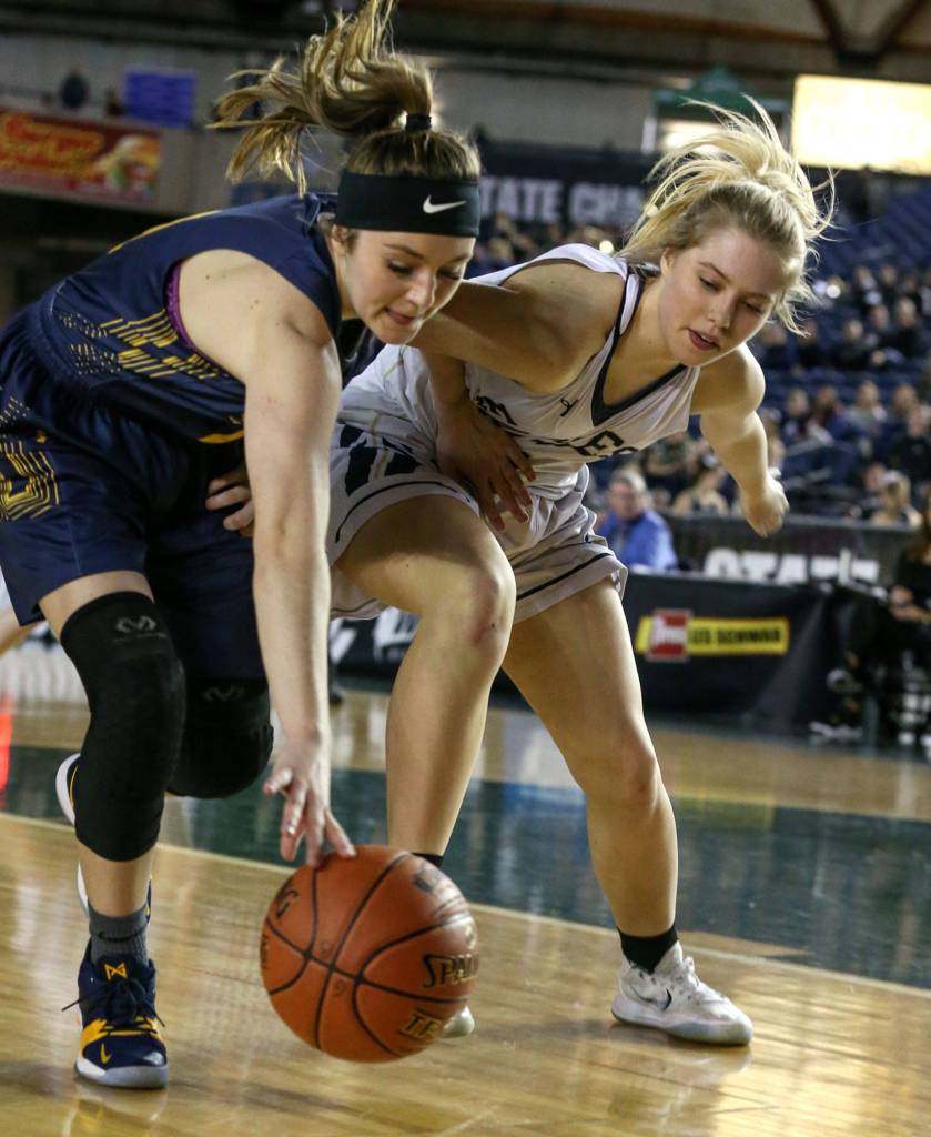 West Seattles Kelsey Lenzie and Arlingtons Abby Schwark vie for a loose ball Wednesday afternoon at the Tacoma Dome on February 27, 2019. The Eagles lost 50-45. (Kevin Clark / The Herald)