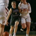 Edmonds-Woodways AJ Martineau brings advances the ball with Prairies Haley Reed on her hip Thursday morning at the Tacoma Dome on February 28, 2019. The Warriors lost 58-39.(Kevin Clark / The Herald)