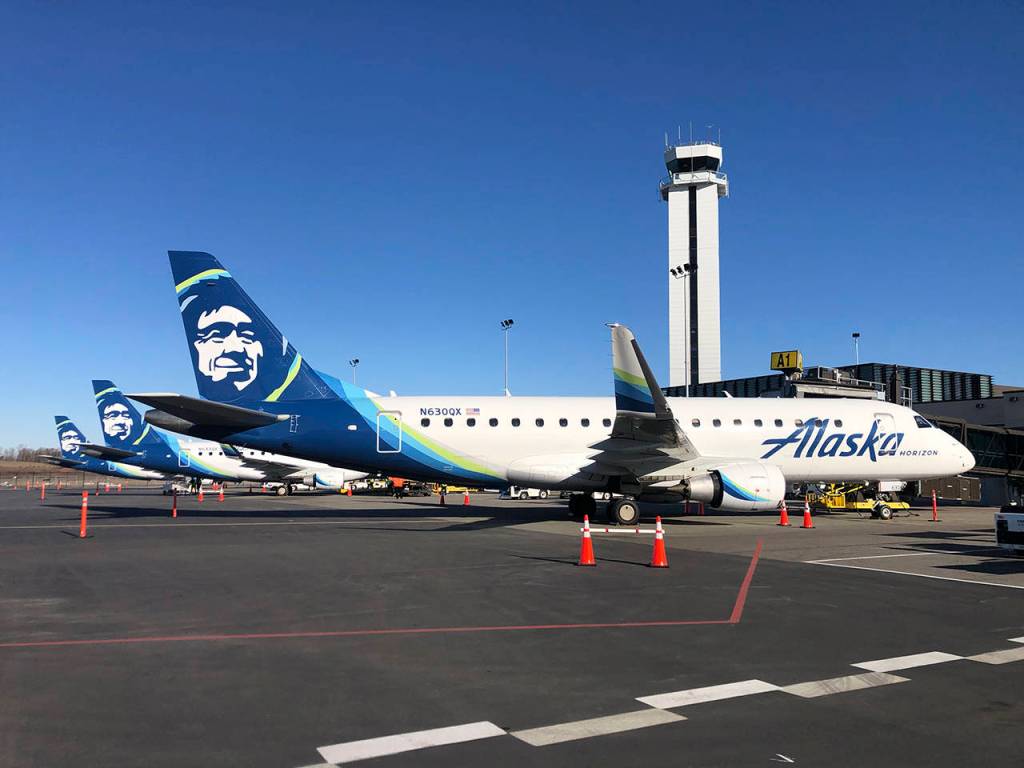 Alaska Airlines planes await the first Paine Field passengers on Monday. (Andy Bronson / The Herald)