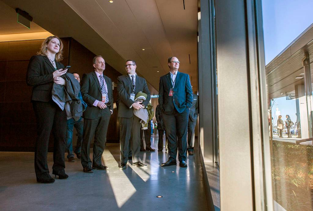 Paine Field airport employees watch the statue unveiling during a grand-opening ceremony on Monday. (Olivia Vanni / The Herald)