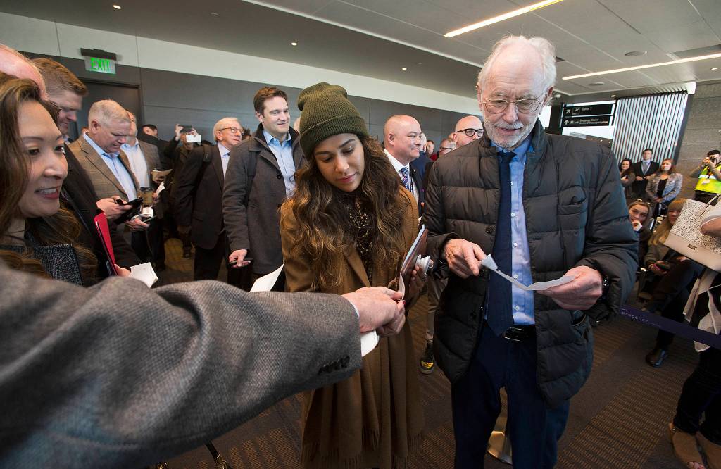 Samantha DeLeon, left, and Joe Clark get their seating arrangements sorted out before boarding the first passenger flight out of Paine Field. (Andy Bronson / The Herald)