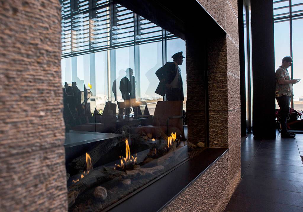 A pilot makes his way through the passenger terminal at Paine Field during a grand opening on Monday. (Olivia Vanni / The Herald)