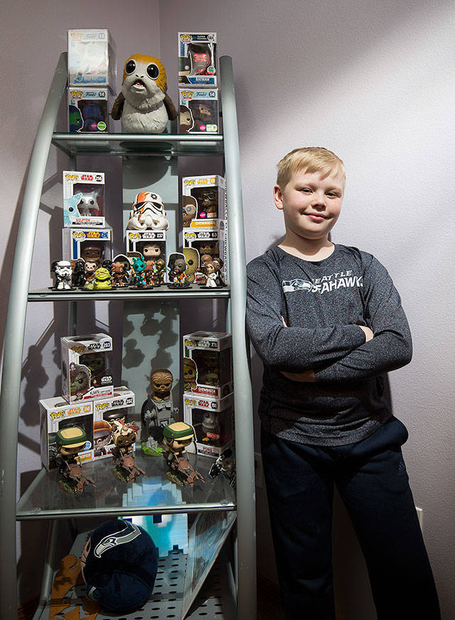 Jagger Twitty, 11, a fifth-grader at Cedarhome Elementary School, keeps Fortnite characters on the shelves in his room to show his love for the video game. He also has some Star Wars characters like Chewbacca and Han Solo. (Andy Bronson / The Herald)