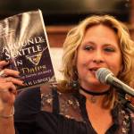 Renata Lubinsky holds a copy of her new book, Around Seattle in 80 Dates. (Kevin Clark / The Herald)