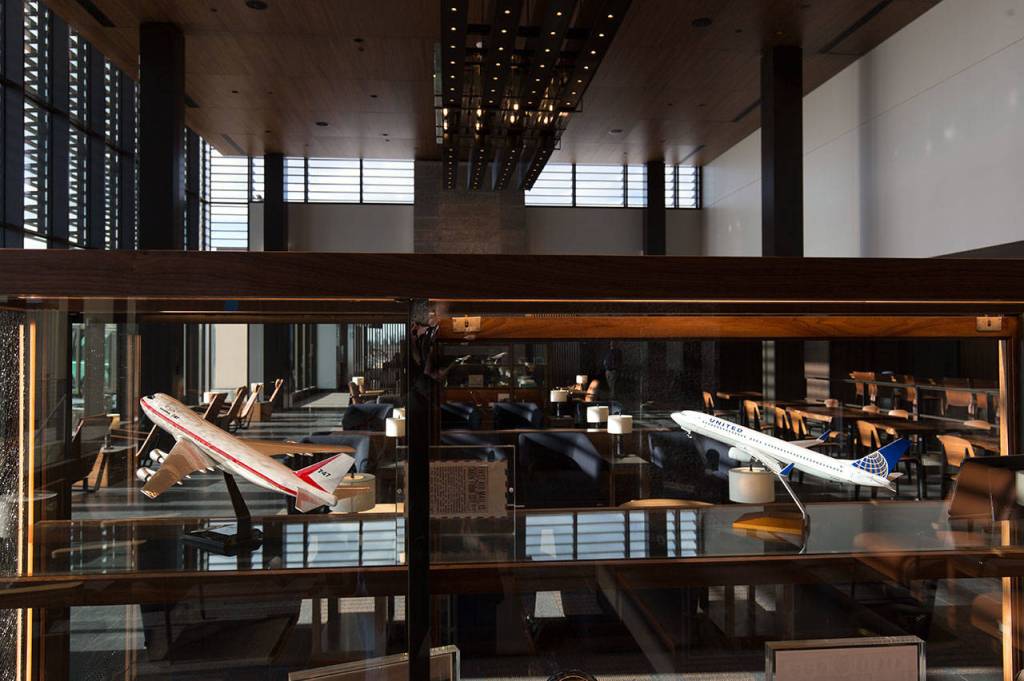 Model planes and other airport memorabilia are set in glass cases in the departure lounge of the Paine Field terminal on Tuesday. (Andy Bronson / The Herald)