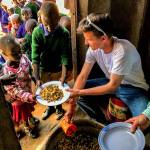 In Tanzania, Elijah Beals helps feed African children during a trip with his father. His dad, Brandon Beals, is the lead pastor at Canyon Creek Church in Mill Creek. (Contributed Photo)