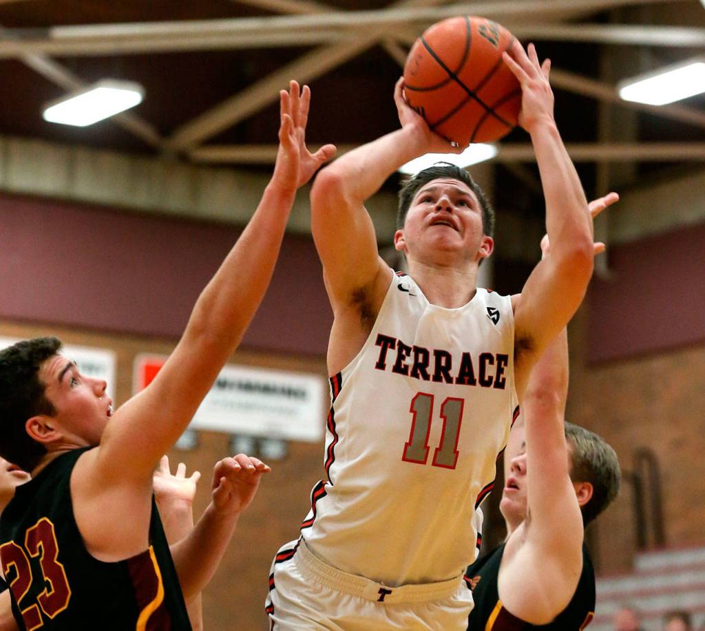 Mountlake Terraces Mason Christianson attempts a shot with Lakesides Jack Dickinson (left) defending during the 2018 Mountlake Terrace High School Holiday Tournament on Dec. 28, 2018. (Kevin Clark / The Herald)