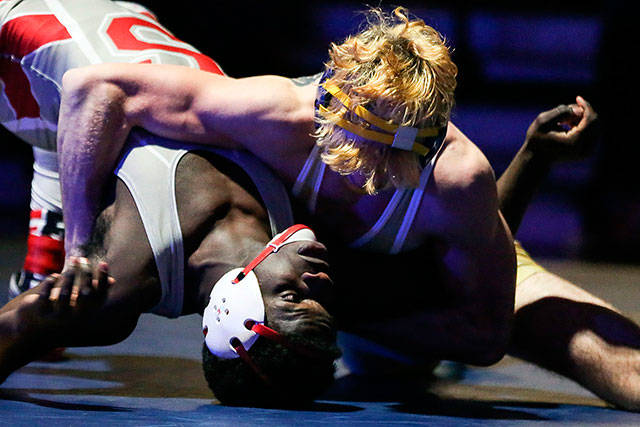 Everetts Riley Bennett attempts to pin Stanwoods Jeremy Williams during a match Jan. 19 at Everett High School. (Kevin Clark / The Herald)