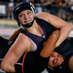 Lake Stevens Kiley Hubby looks to the clock as she works to pin Kennewicks Alexia Asselin during Mat Classic XXXI at the Tacoma Dome on Feb. 15. (Kevin Clark / The Herald)
