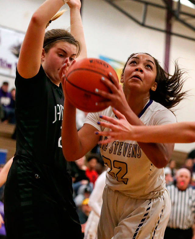 Lake Stevens Raigan Reed (right) looks to score with Jacksons Olivia Skibiel defending during a game Jan. 15 at Lake Stevens High School. (Kevin Clark / The Herald)