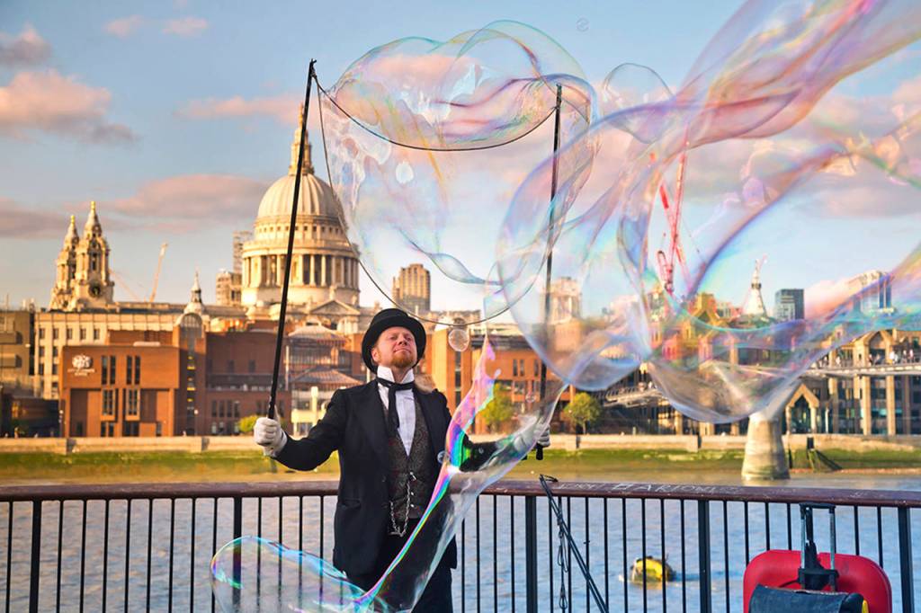A street performer in London, with St. Pauls Cathedral in the background. (Rick Steves Travel)