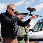 In this Feb. 23 photo, acting Secretary of Defense Patrick Shanahan center fires a modified painted ball gun that shoots pepper balls during a tour of the US-Mexico border at Santa Teresa Station in Sunland Park, New Mexico. (AP Photo/Pablo Martinez Monsivais)