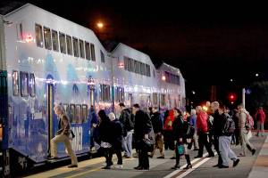 Passengers board a Sounder heading toward Seattle at the Edmonds Station, one of two in Snohomish County where Sound Transit will start offering parking permits.                                (Michael OLeary/ Herald File)