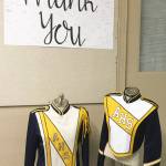 The new uniform coats bear the same familiar AHS blue and gold, only now the colors are no-fade, with blue in the sleeves, epaulets and collar, and a gold sash across abright white chest. (The Arlington Times)