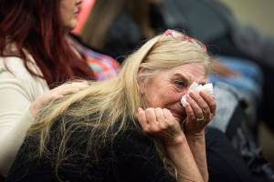Beth Hynek reacts as family members talks about Julie Knetchel, an Everett mother who was shot to death while trying to protect her son from armed intruders. (Andy Bronson / The Herald)