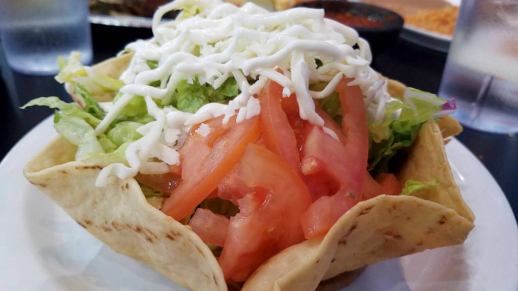 This vegetarian version of the taco salad is served with tomatoes, lettuce and beans and cheese. (Sharon Salyer/The Herald)