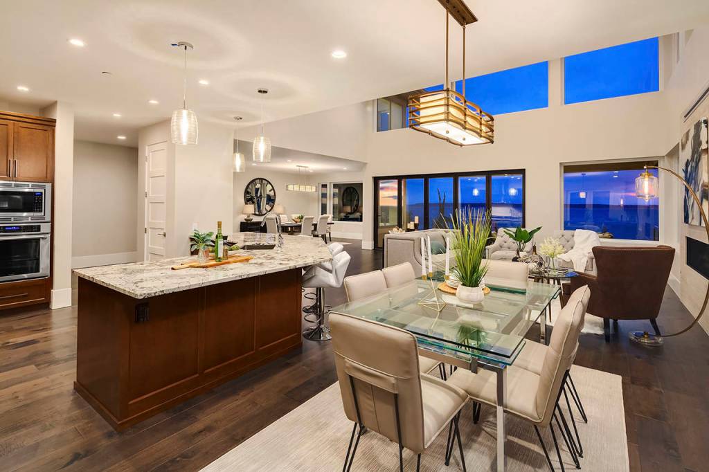 The kitchen features slab granite, a stainless sink and a lighted coffee bar, while the dining room has windows with a view. (Andrew Parsons)