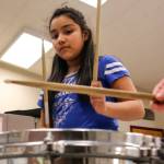 Lynette Milly Milagros pounds a beat during practice at Challenger Elementary in Everett. (Kevin Clark / The Herald)