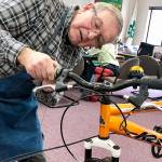 Dave Fox is among a dozen volunteers donating time at the Repair Cafe, a free monthly event where people bring things to be fixed. It is hosted by WSU Snohomish County Extension in McCollum Park. (Andrea Brown / The Herald)