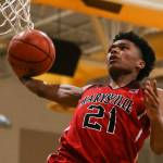RaeQuan Battle winds up for a dunk during his record-breaking performance against Edmonds-Woodway on Dec. 14. Battle poured in a school-record 43 points, grabbed 23 rebounds and made a game-winning layup at the buzzer. (Kevin Clark / The Herald)