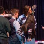 As his teammates celebrate their win, Jake Spores kisses a trophy after Stanwood High won the Hi-Q academic quiz competition championship held at Stanwood High School on Friday. Stanwood beat out Monroe and Archbishop Murphy for the win. (Andy Bronson / The Herald)