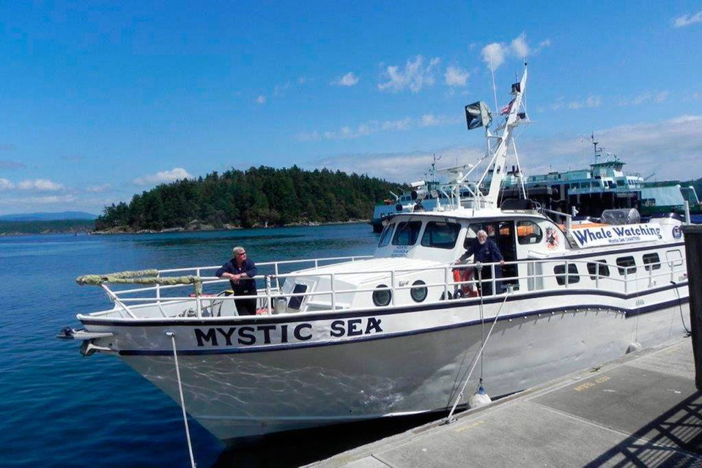Capt. Monte Hughes, in the bow, and crew member Dick Snowberger wait for the M/V Mystic Sea to pass an inspection. (Sandra Pollard)