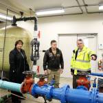 Coupeville Mayor Molly Hughes and Naval Air Station Whidbey Island base commander Capt. Matt Arny (center) listen as town Utility Superintendent Joe Grogan explains how water is currently treated and how that will work with the new filtration system. The Navy is paying for a new water treatment plant to remove toxic chemicals called PFAS. (Laura Guido / Whidbey News-Times)