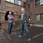 Father-and-son travel experts Rick (right) and Andy Steves stand in front of the Rick Steves Europe building on Jan. 10 in Edmonds. (Andy Bronson / The Herald)