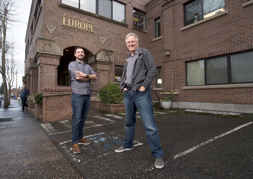 Father-and-son travel experts Rick (right) and Andy Steves stand in front of the Rick Steves Europe building on Jan. 10 in Edmonds. (Andy Bronson / The Herald)