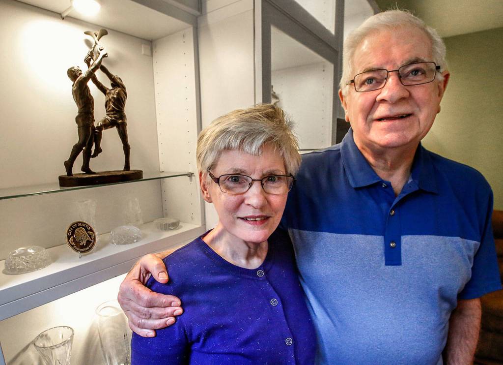 With a bronze sculpture of the Irish sport of hurling in the background, John Keane and his wife Maureen talk about his homeland, his role as Honorary Consul of Ireland in Seattle, and American St. Patricks Day traditions they dont observe. (Dan Bates / The Herald)