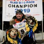 Peter Kaiser (9) poses with his lead dogs, Morrow (Left) and Lucy on Wednesday in Nome, Alaska. Kaiser had just won the Iditarod Trail Sled Dog Race in his 10th attempt. (Marc Lester/Anchorage Daily News via AP)